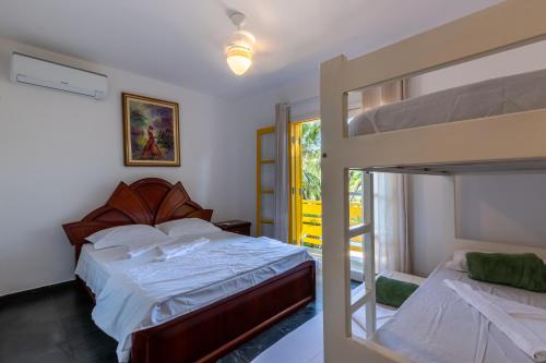 a bedroom with two bunk beds and a balcony at Positano Ilhabela Lodges in Ilhabela