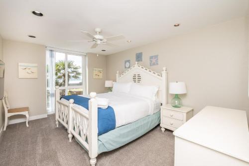 a bedroom with a white bed and a window at D-31 Beachfront Bliss in Oceanside