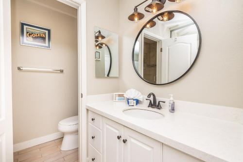 a bathroom with a sink and a mirror at D-31 Beachfront Bliss in Oceanside