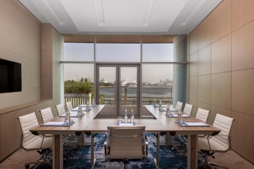 a large conference room with a long table and chairs at Marriott Marquis Dubai Creek in Dubai