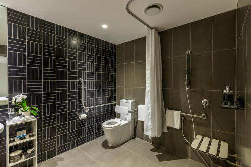 a bathroom with a toilet and a shower at Corporate Living Accommodation Abbotsford in Melbourne