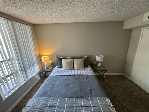 a bedroom with a bed and a large window at Incredible Two Bedroom Hollywood Apartments FREE Parking in Los Angeles