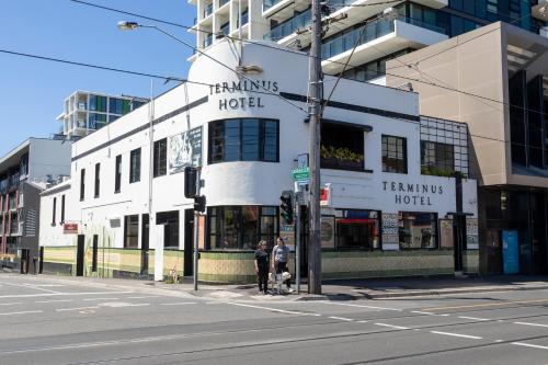 two people standing on a street corner in front of a building at Corporate Living Accommodation Abbotsford in Melbourne