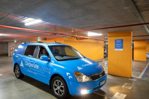 a blue car parked in a parking garage at Corporate Living Accommodation Abbotsford in Melbourne