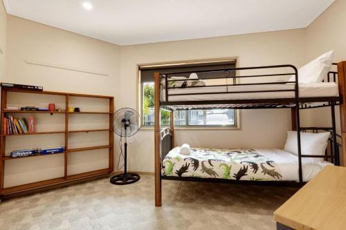 a bedroom with two bunk beds and a desk at Clipper Cove in Paynesville