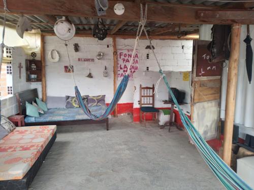 a room with two hammocks hanging from a wall at Casa de la Abuela in Jardin