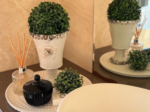 a table with two vases with plants on it at Wake Up to Stunning Views - Luxury Counrty Escape by Scotch Hill Truffle Farm in Neerim South