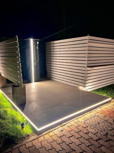 a concrete patio with a wooden fence at night at Villa Latino in Vieste