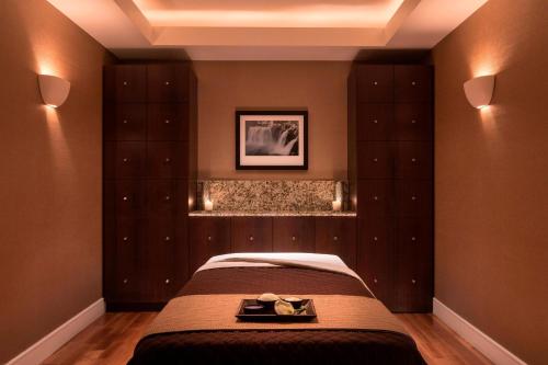 a bedroom with a bed and some cabinets at The Ritz-Carlton, Denver in Denver