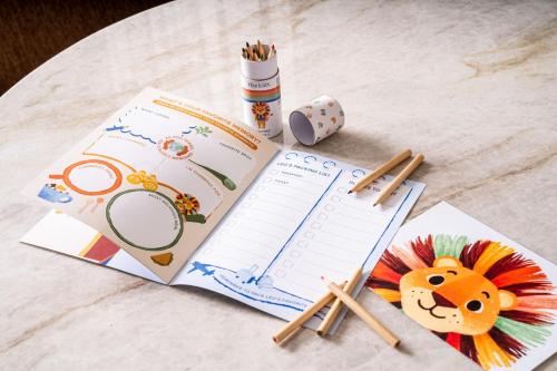 a table with a book and pens and pencils at The Ritz-Carlton, Denver in Denver