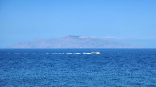 a boat in the middle of a large body of water at Casinha Nova - Comfort & Class in Fogo in São Filipe