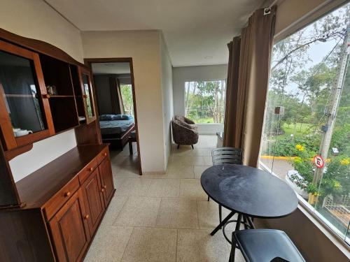 a kitchen with a table and a dining room at Pousada dos Filhos in Arcoverde
