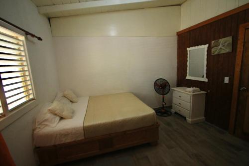 a bedroom with a bed and a dresser and a window at Casa Rural El Paraíso de Saona in Mano Juan