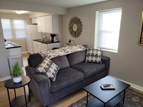 a living room with a couch and a kitchen at Davenport Dwellings-Two Bedroom in Omaha