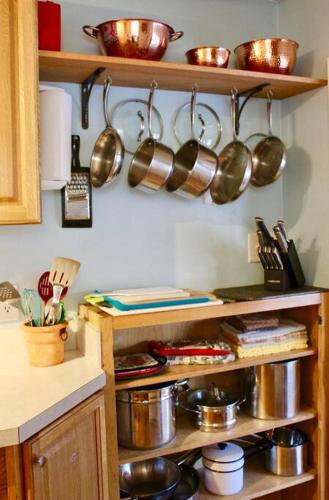 a kitchen with wooden shelves with pots and pans at Riverfront Property in NRG National Park near Sandstone Falls- Wi-Fi, Pet-Friendly in Hinton