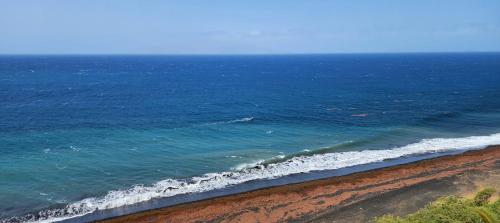 an aerial view of the ocean and a beach at Casinha Nova - Comfort & Class in Fogo in São Filipe