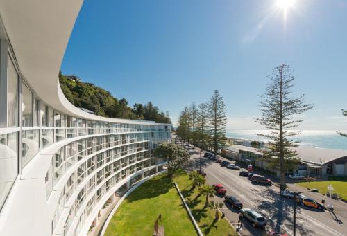 an exterior view of a building with a street at Scenic Hotel Te Pania in Napier