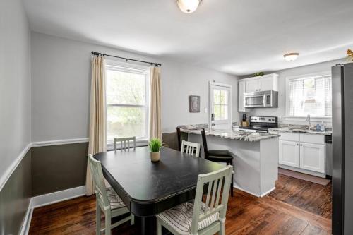 a kitchen with a table and chairs and a dining room at Private House + Yard Central Location to all RVA in Richmond