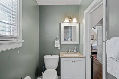 a bathroom with a toilet and a sink at Private House + Yard Central Location to all RVA in Richmond