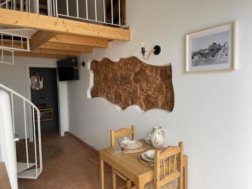 a dining room with a wooden table and a staircase at Monte Gerações - Heated pool - Typical Algarvian - close to Quinta Lago, Vale Lobo and Vilamoura in Almancil