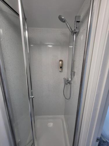 a shower in a bathroom with a glass door at Stay Sleep Rest - Forest Road in Nottingham