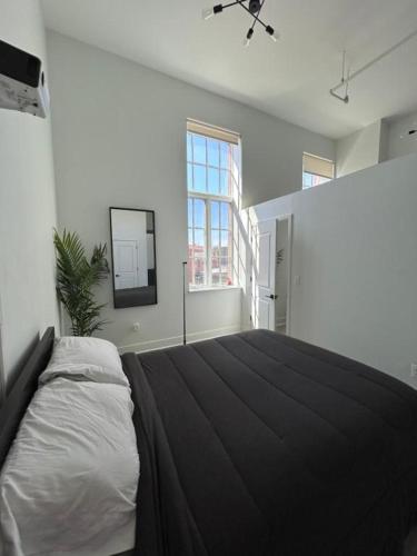 a bedroom with a large bed and a window at White Baltimore Condo in Baltimore