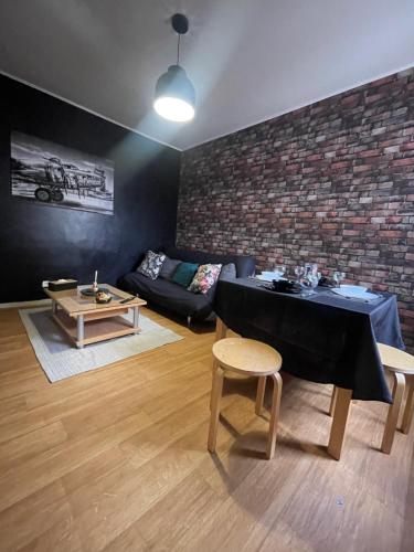 a living room with a table and a couch at Appartement spacieux & lumineux proche paris in Villeneuve-Saint-Georges