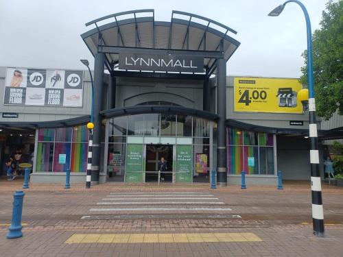 a shopping center with an entrance to a mall at cosy home in New Lynn in Auckland