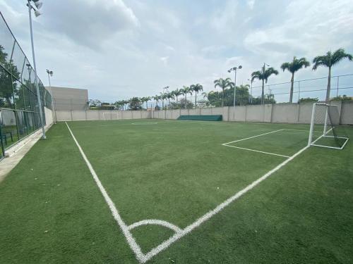 a tennis court with a net on a soccer field at Minisuite entrada lateral, seguridad y privacidad in SamborondÃ³n