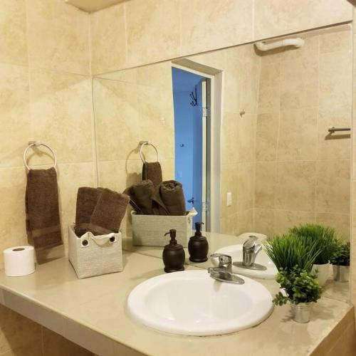 a bathroom counter with a sink and a mirror at Departamento Comodo centrico Tv Ac wifi cocina parking, letra C in Ciudad Valles