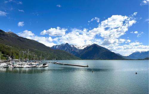a marina with boats in the water with mountains at 1 Bedroom Beautiful Apartment In Domaso in Domaso