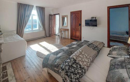 a bedroom with a bed and a television in it at Lovely Home In Feignies With Wifi in Feignies