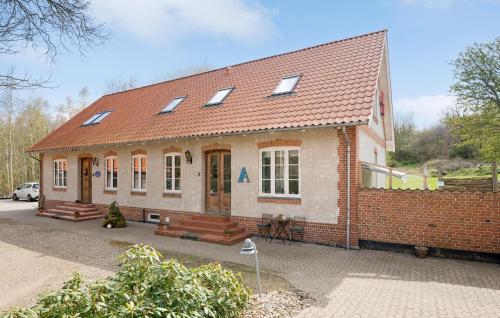 a small brick house with a red roof at 3 Bedroom Lovely Apartment In Engesvang in Engesvang