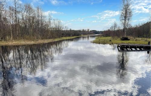 a river with a reflection of clouds in the water at 4 Bedroom Stunning Home In Åsenhöga in Åsenhöga