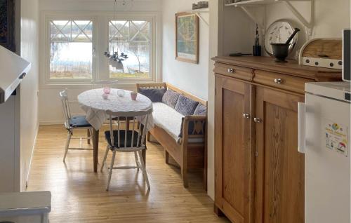 a kitchen with a table and chairs and a dining room at Beautiful Home In Trans With Kitchen in Tranås
