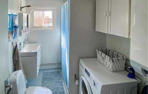a bathroom with a washing machine and a sink at Beautiful Home In Trans With Kitchen in Tranås