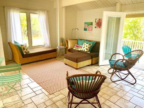 a living room with a couch and chairs at North Shore Garden Suite in Haleiwa