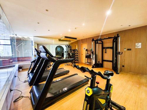a gym with exercise bikes in a room at Madison 101 Hotel + Tower in Manila