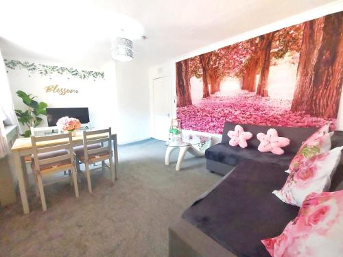 a living room with a wall covered in pink flowers at The Blossom - Largs in Largs