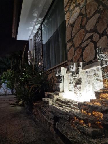 a stone building with a window at night at Villa "OLD FISHERMAN'S" in Taranto