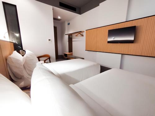 Postel nebo postele na pokoji v ubytování Ando Hotel Batam