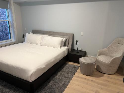 a bedroom with a bed and a chair in it at The Monty Boston in Boston
