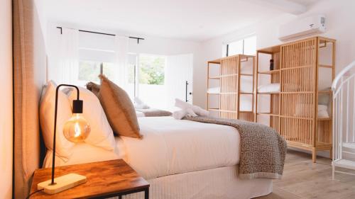 a white bedroom with a bed and a table at Lake Metung in Metung
