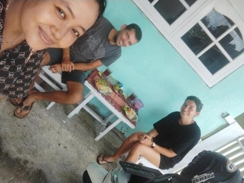 a group of people standing around a table in a house at Nio Homestay and Tour in Licin