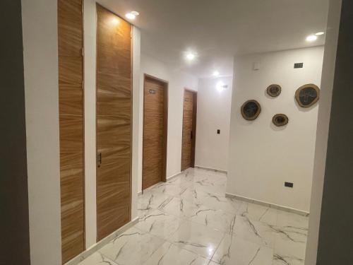 a hallway with wooden doors and marble floors at Alce33 in Cancún