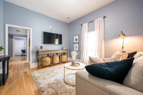 a living room with a couch and a table at Affordable, Quaint Retreat! 5 Mins to Downtown in Indianapolis
