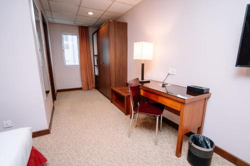 a hotel room with a desk and a room at Jewels Hotel in Kota Bharu