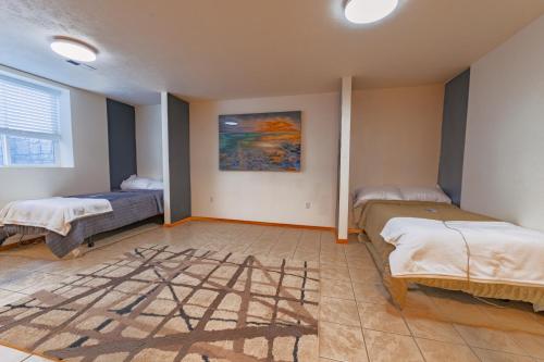 a room with two beds and a painting on the wall at Closer to Northern Quest Casino, Fairchild AFB Spokane Intl Airport Indian Canyon and Sacred Heart Hospital in Spokane