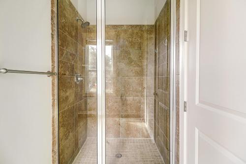 a shower with a glass door in a bathroom at Casa de Flip Flops in Rockport