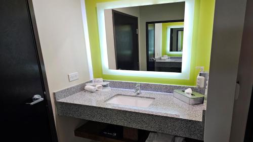 a bathroom with a sink and a large mirror at Holiday Inn Express & Suites Mexicali by IHG in Mexicali